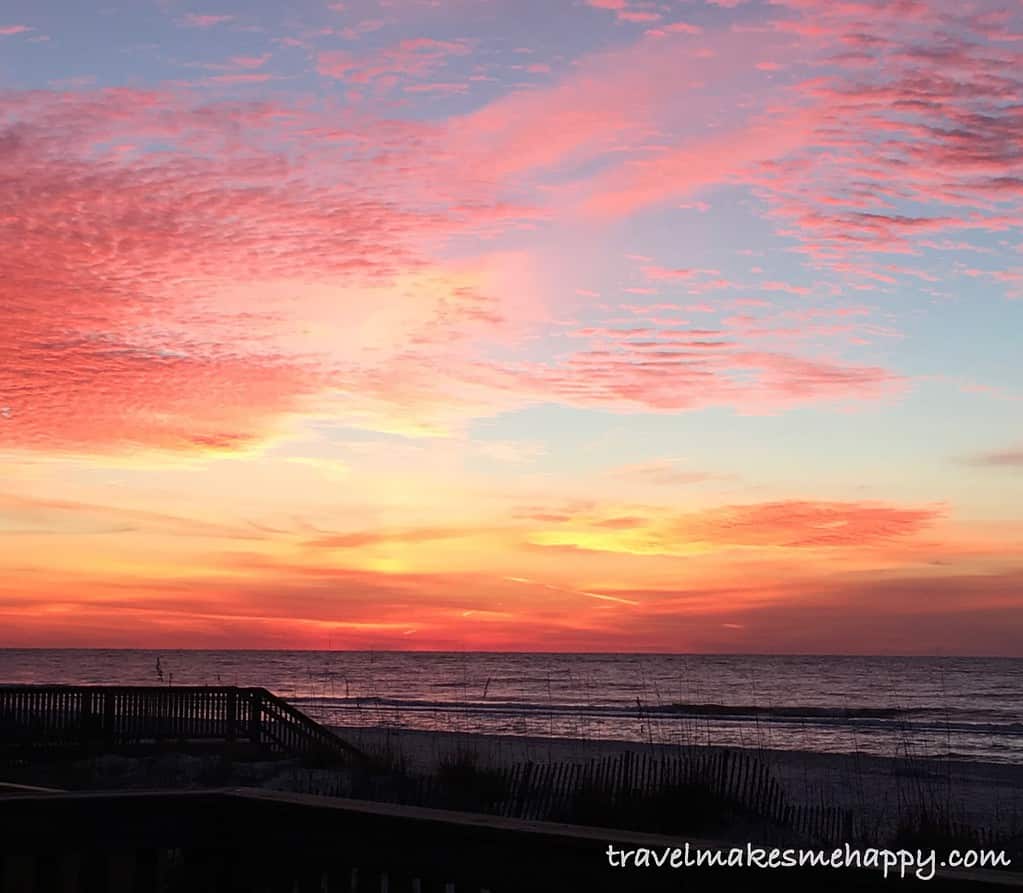 sunset with pink clouds at the beach