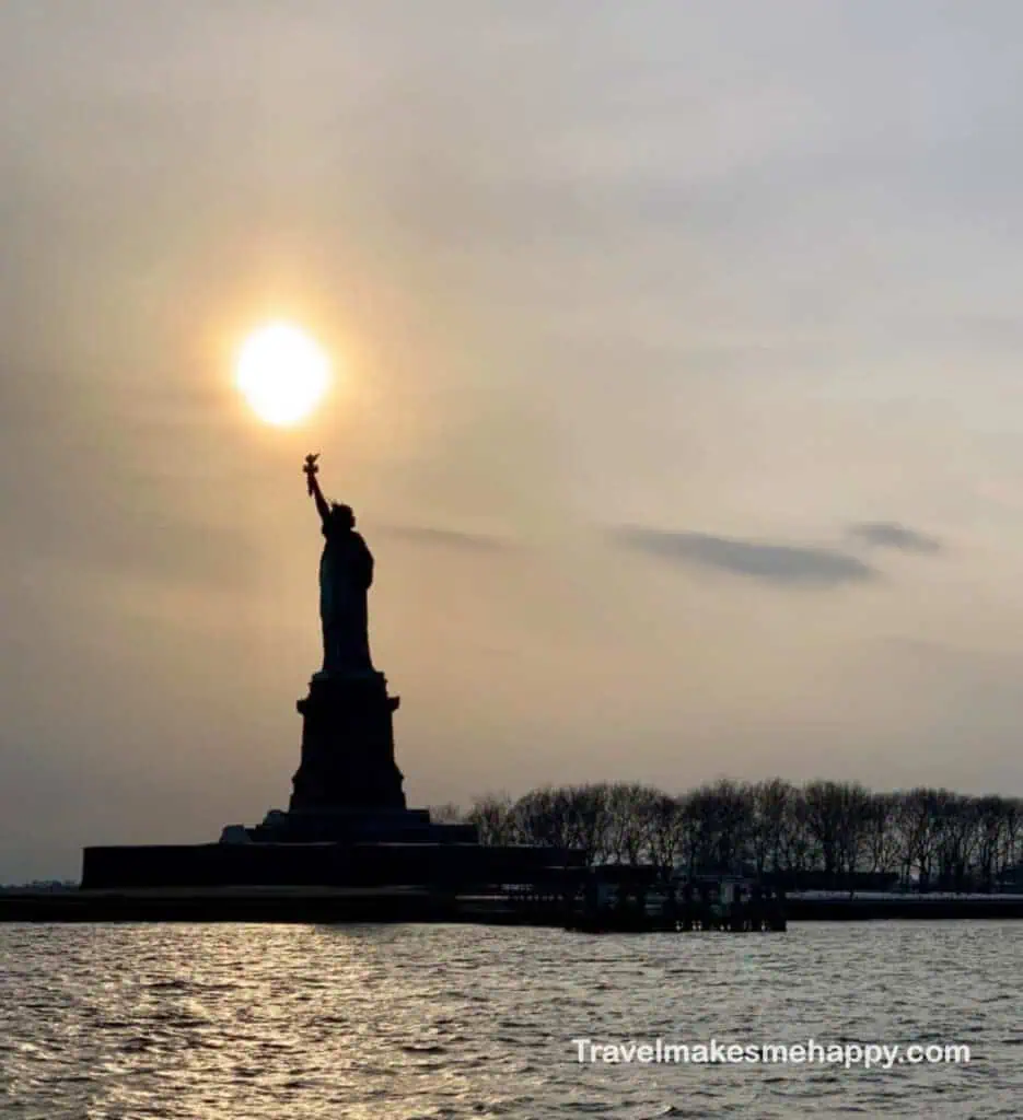 Statue of Liberty at sunset staten island ferry view
