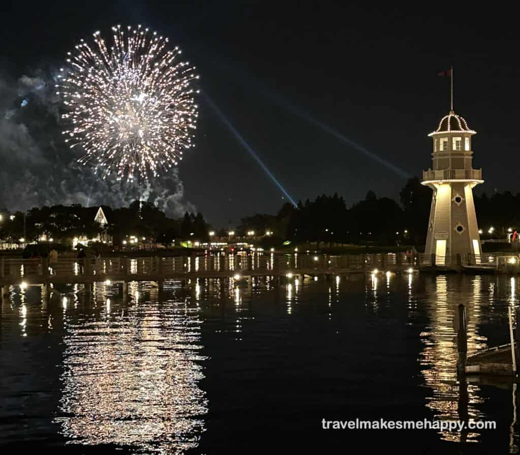 disney fireworks on lake with lighthouse