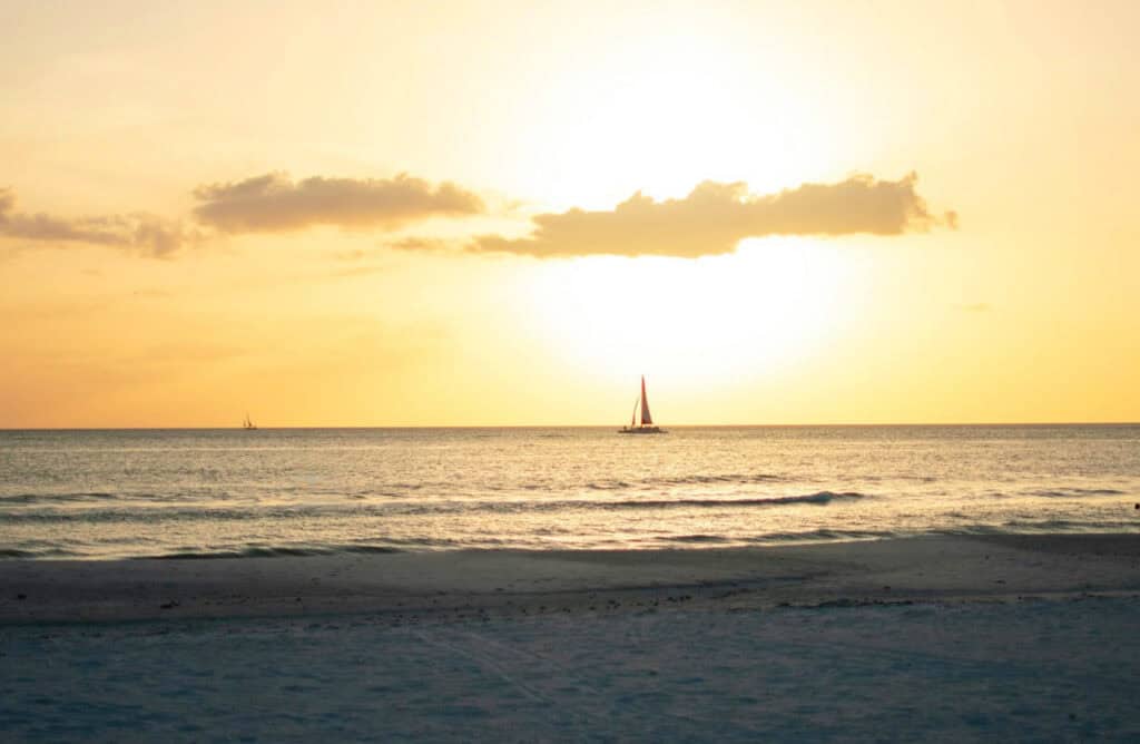 sunset on clearwater beach with sailboat top spot