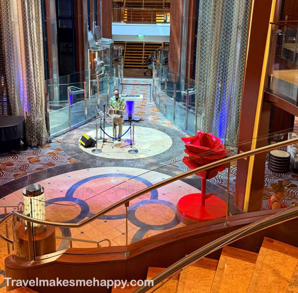 live music on celebrity reflection cruise ship atrium with giant red rose sculpture